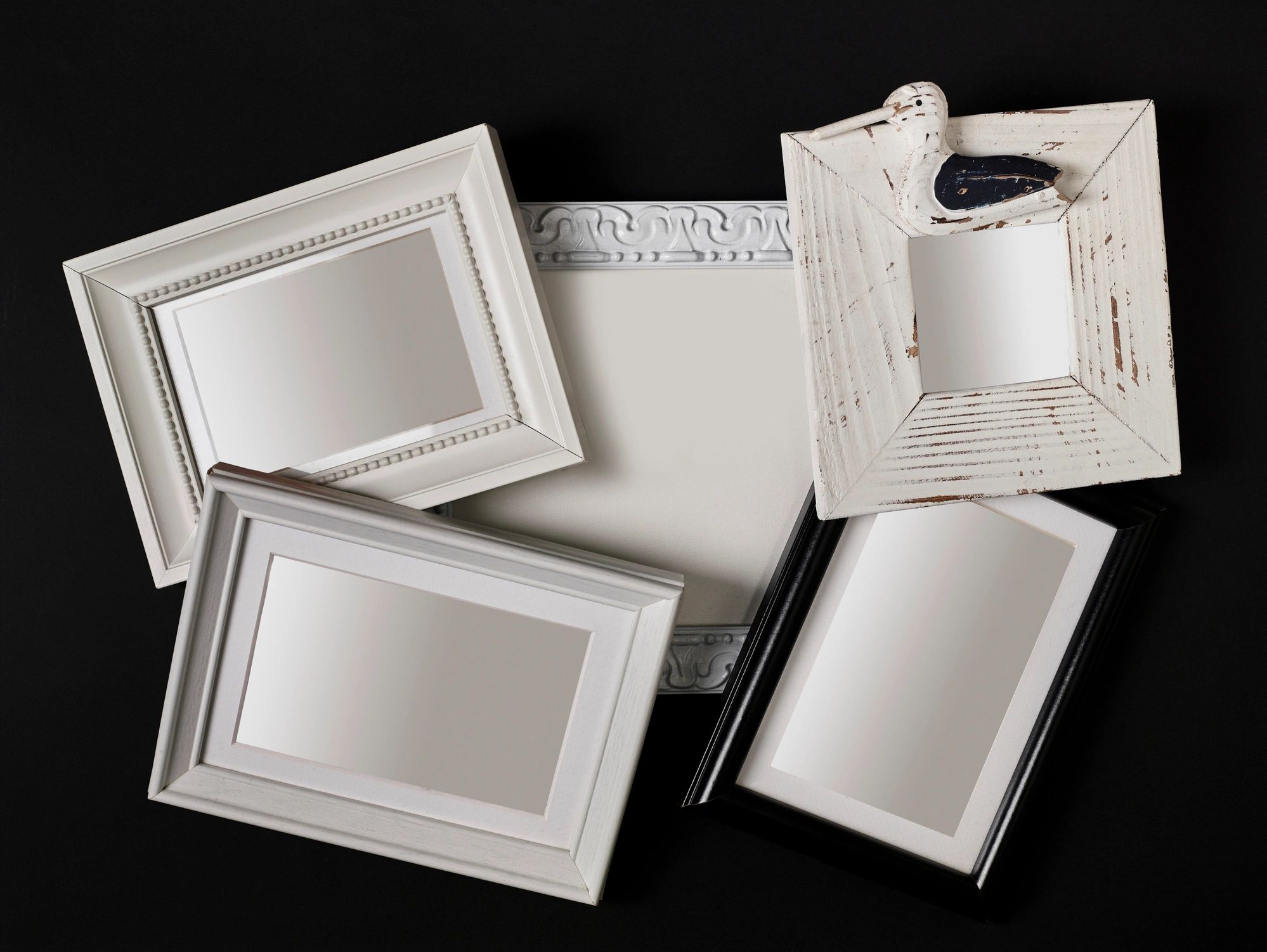 Stack of empty picture frames on a dark background
