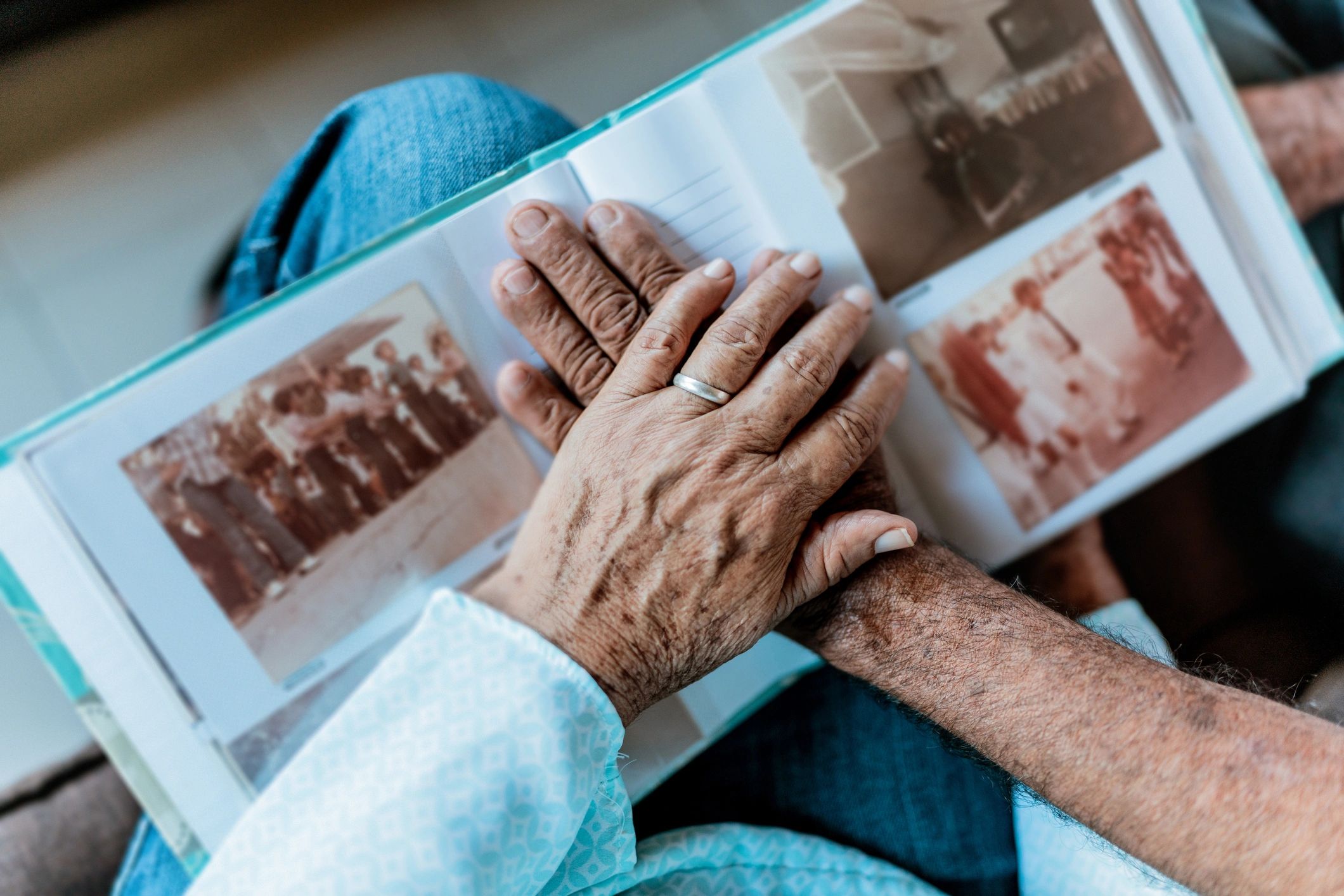 Close-up of hands resting on a photo album