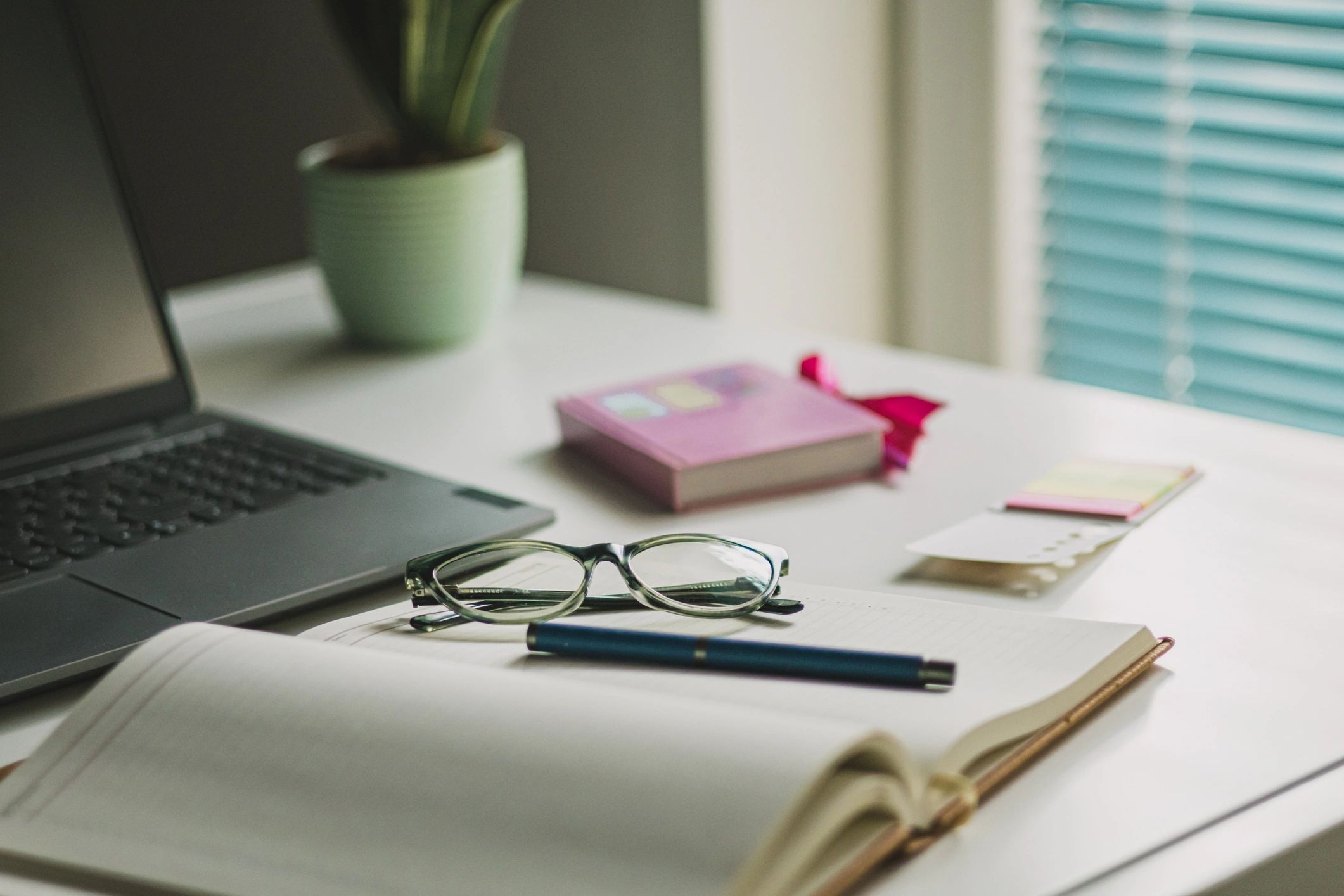 Desk with laptop, coffee, and office supplies