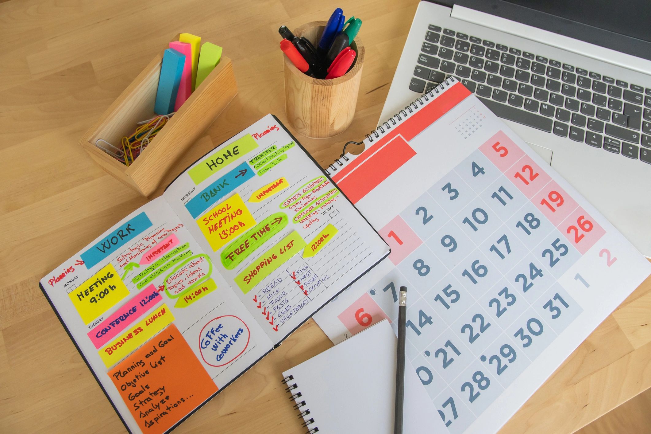 Open planner and calendar on a desk for event planning