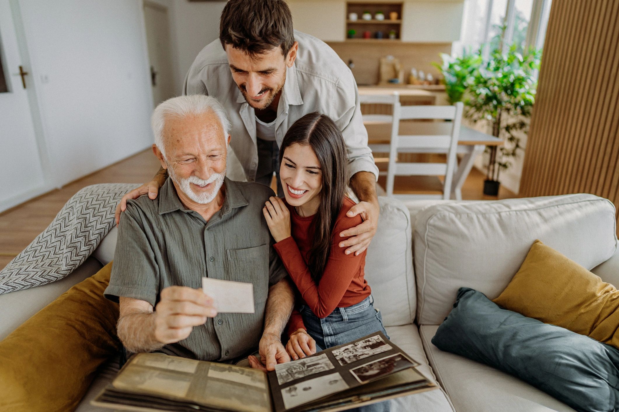 Grandparent and grandchildren looking at old photographs