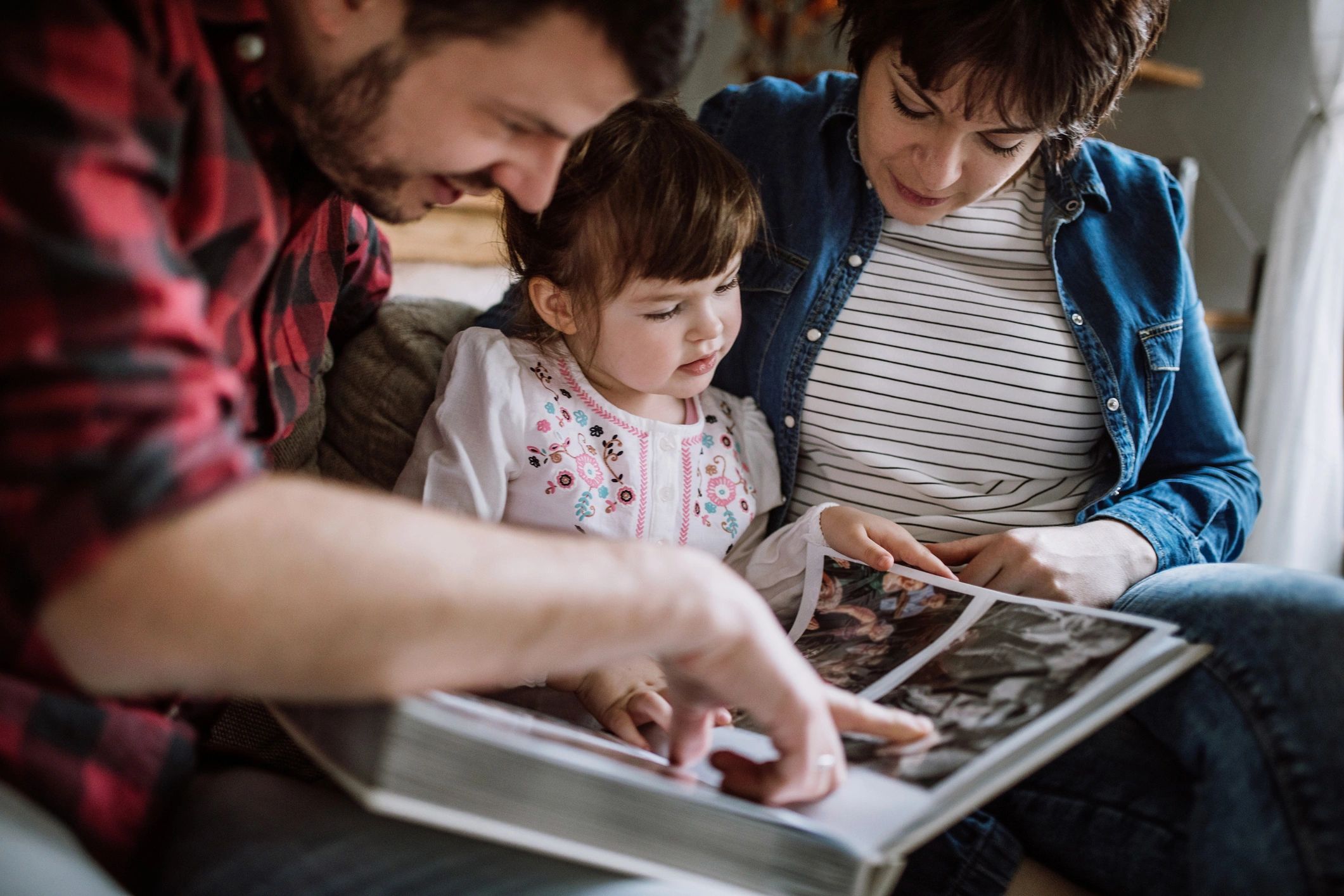 Family members looking through an old photo album together