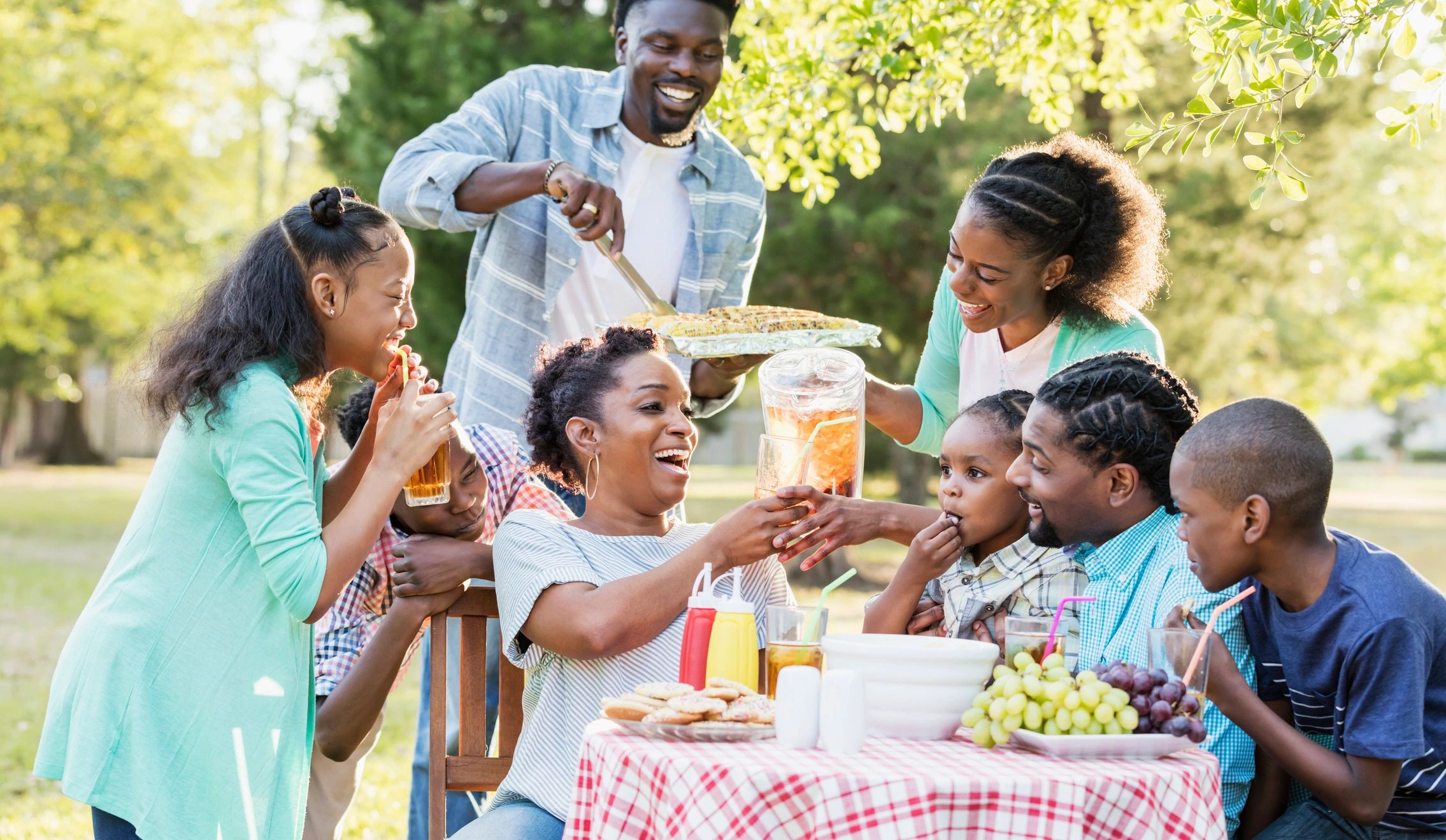 Large family gathered outdoors at a cookout